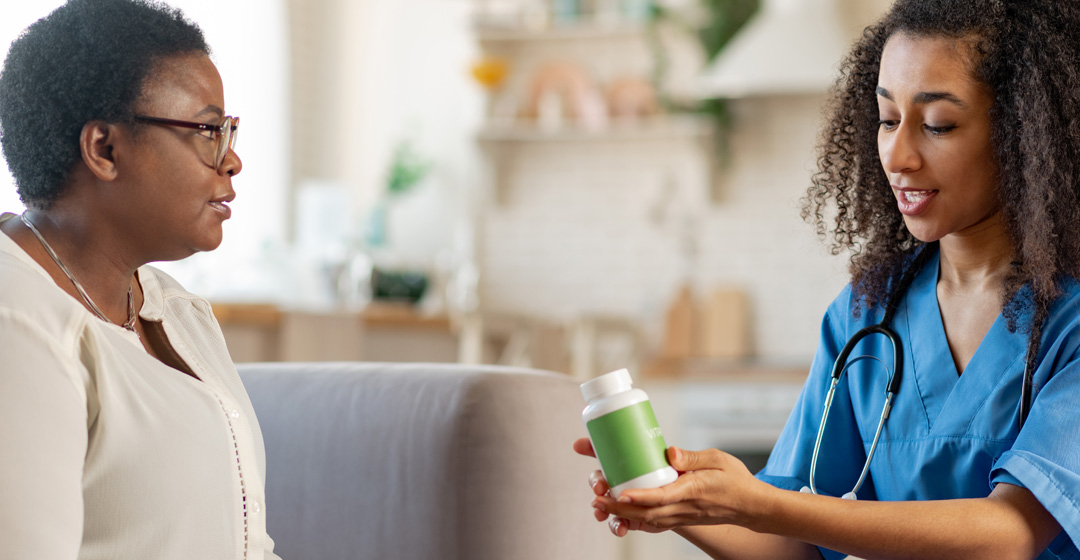 Nurse showing medication to patient Nurse showing medication to patient